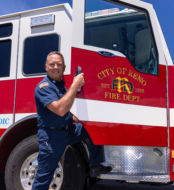 Firefighter next to fire truck