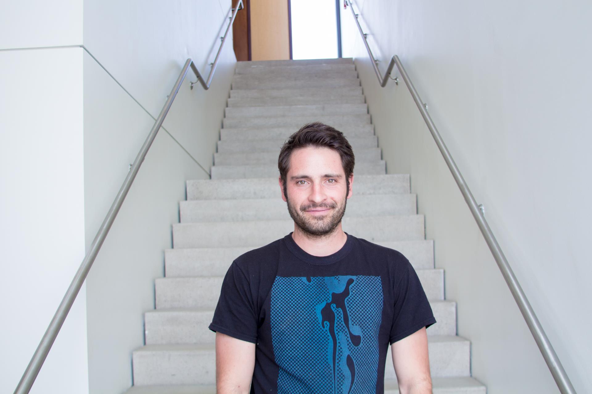 City Artist Tom Drakulich standing in a white stairwell