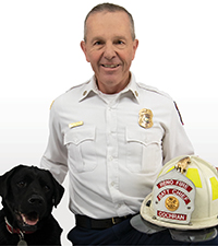 David Cochran holding fire helmet