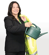 Trina Magoon with a watering can and construction vest