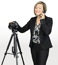 Rebecca Venis talking on a phone in front of a camera on a tripod