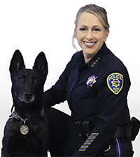 Kathryn Nance with a black K-9 dog