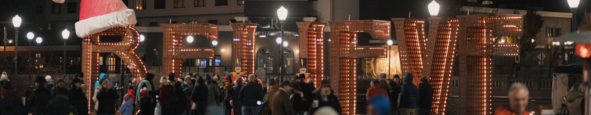 People gather near the Believe scuplture for the Holiday Lights festival and tree lighting.