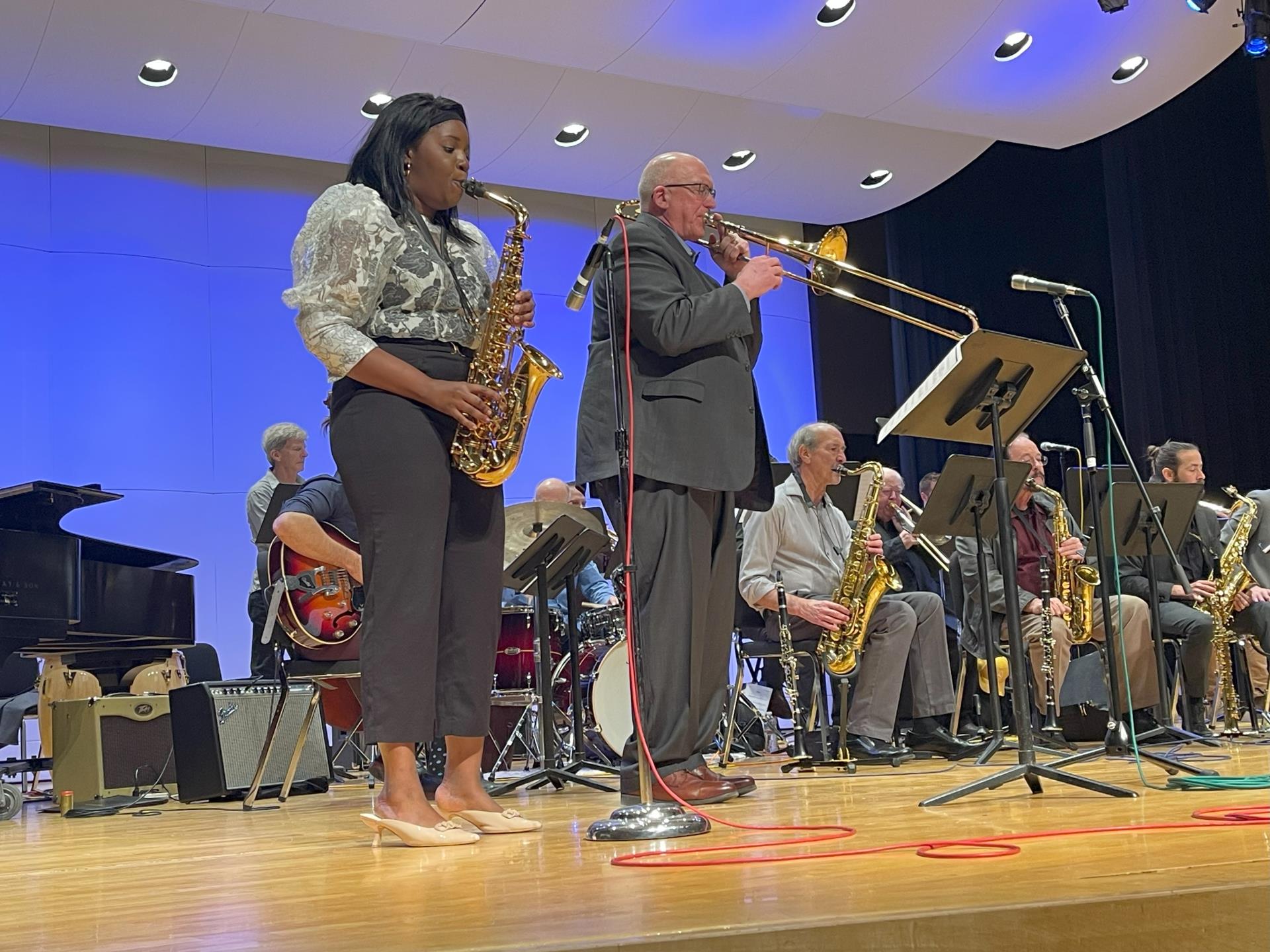 Two musicians playing brass instruments on a stage