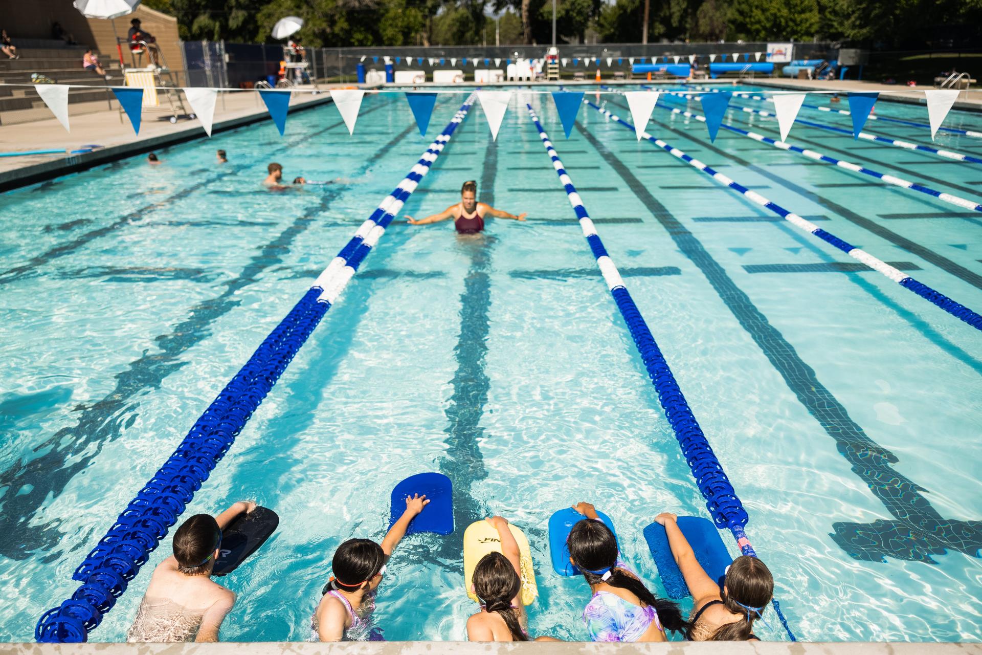 Children using kickboards in swimming lessons