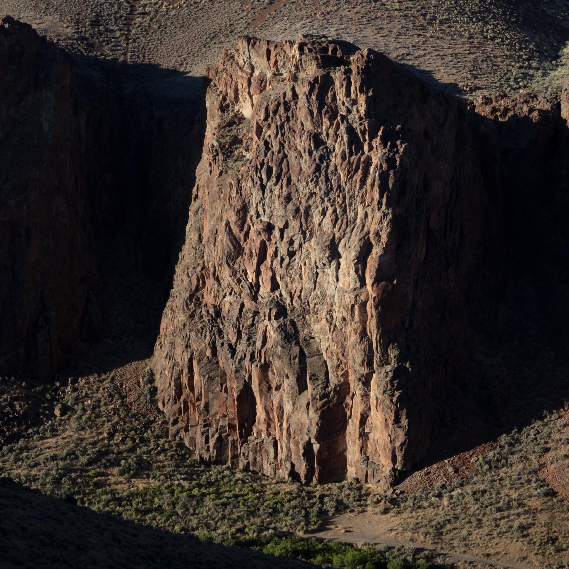 FRIENDS OF BLACK ROCK 2024 image shows a large rock formation jutting out of black shadow